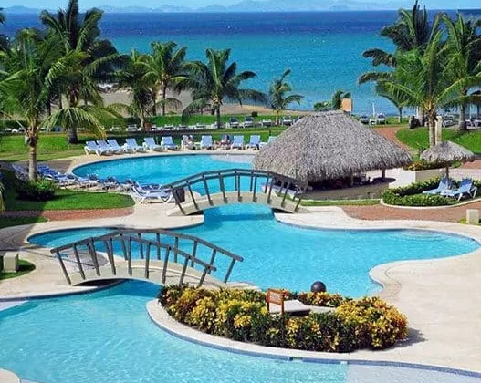 view of a beautiful swimming pool that leads towards the ocean