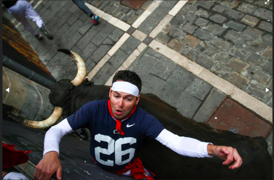 One runner gets a little too close and personal with a two-ton bull. 
